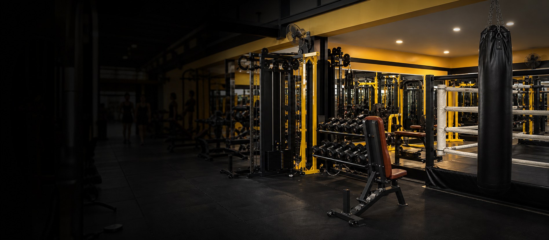Oxy Gym style Muay Thai and fitness space with black and yellow equipment